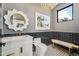 Stylish powder room with white vanity, dark tile, and unique mirror at 9809 E Desert Cove Ave, Scottsdale, AZ 85260