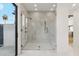 Large walk-in shower with marble tile and glass enclosure at 9809 E Desert Cove Ave, Scottsdale, AZ 85260