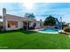 Spacious backyard with a refreshing pool and lush grass at 9880 E Pine Valley Rd, Scottsdale, AZ 85260