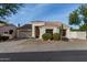 Single-story home with a two-car garage and desert landscaping at 9880 E Pine Valley Rd, Scottsdale, AZ 85260