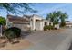 Front view of a single-story house with a two-car garage at 9880 E Pine Valley Rd, Scottsdale, AZ 85260