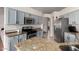 Kitchen boasts granite countertops, stainless steel appliances, and blue cabinets at 9880 E Pine Valley Rd, Scottsdale, AZ 85260