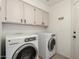 Laundry room with washer, dryer, and cabinets at 9880 E Pine Valley Rd, Scottsdale, AZ 85260