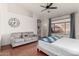 Main bedroom with hardwood floors, ceiling fan, and large window with pool view at 9880 E Pine Valley Rd, Scottsdale, AZ 85260