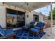 Covered patio features wicker furniture and blue accents at 9880 E Pine Valley Rd, Scottsdale, AZ 85260