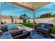 Peaceful patio with comfortable seating overlooking the pool at 9880 E Pine Valley Rd, Scottsdale, AZ 85260