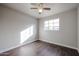 Well-lit bedroom with wood-look floors and ceiling fan at 1022 S Lola Ln, Tempe, AZ 85281