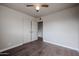 Bedroom with wood-look floors, ceiling fan, and closet at 1022 S Lola Ln, Tempe, AZ 85281