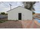 Detached garage with metal door and adjacent patio at 1022 S Lola Ln, Tempe, AZ 85281