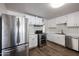 Updated kitchen with stainless steel appliances and white cabinets at 1022 S Lola Ln, Tempe, AZ 85281