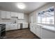 Updated kitchen with white cabinets and new countertops at 1022 S Lola Ln, Tempe, AZ 85281