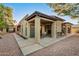 Desert landscape surrounds this home's private backyard with covered patio and seating area at 10302 E Lotus Ct, Chandler, AZ 85248