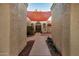 Courtyard entry with terracotta tile flooring and red shade sail at 10302 E Lotus Ct, Chandler, AZ 85248