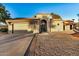 Single story home with arched entry and two-car garage at 10302 E Lotus Ct, Chandler, AZ 85248