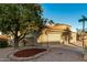 Home's exterior features a two-car garage and manicured landscaping at 10302 E Lotus Ct, Chandler, AZ 85248