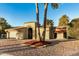 House exterior showcasing a desert landscape and two palm trees at 10302 E Lotus Ct, Chandler, AZ 85248