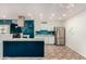 Modern kitchen with teal accents, stainless steel appliances, and a breakfast bar at 10517 W Diana Ave, Peoria, AZ 85345