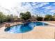 Inviting kidney-shaped pool with a waterfall feature in the backyard at 10517 W Diana Ave, Peoria, AZ 85345