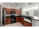 Modern kitchen featuring dark wood cabinets and granite countertops at 11640 N Tatum Blvd # 2079, Phoenix, AZ 85028