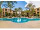 Inviting community pool with palm trees and lounge chairs at 11640 N Tatum Blvd # 2079, Phoenix, AZ 85028