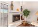 Cozy fireplace with decorative vases and a potted plant at 12017 N 27Th Pl, Phoenix, AZ 85028