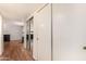 Hallway with wood floors and mirrored closet doors at 12017 N 27Th Pl, Phoenix, AZ 85028