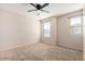 Bright bedroom with carpet flooring, ceiling fan, and two windows at 1333 N Balboa --, Mesa, AZ 85205