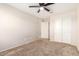 Bedroom with carpet floors, ceiling fan and access to hallway and another room at 1333 N Balboa --, Mesa, AZ 85205