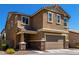 Two-story house with tan siding, stone accents, and a two-car garage at 1333 N Balboa --, Mesa, AZ 85205