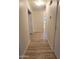 Bright hallway with light wood laminate flooring and access to other rooms at 13383 W Ironwood St, Surprise, AZ 85374