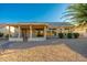 Covered patio and desert landscaping in backyard at 13708 W Robertson Dr, Sun City West, AZ 85375