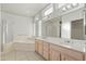 Bathroom with double vanity, bathtub, and shower at 13708 W Robertson Dr, Sun City West, AZ 85375