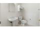 Simple guest bathroom with pedestal sink and toilet at 13708 W Robertson Dr, Sun City West, AZ 85375