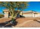 Tan one-story house with tile roof and desert landscaping at 13708 W Robertson Dr, Sun City West, AZ 85375