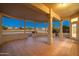 Spacious covered patio with tile flooring, offering scenic golf course views at 13708 W Robertson Dr, Sun City West, AZ 85375