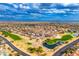 Aerial view of a golf course community with houses and a lake at 14328 W Dusty Trail Blvd, Sun City West, AZ 85375