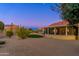 Backyard view at dusk, showcasing the home's exterior and landscaping at 14328 W Dusty Trail Blvd, Sun City West, AZ 85375