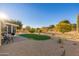 Landscaped backyard with putting green and patio at 14328 W Dusty Trail Blvd, Sun City West, AZ 85375