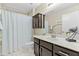 Clean bathroom with dark brown vanity and shower/tub combo at 14328 W Dusty Trail Blvd, Sun City West, AZ 85375