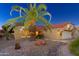 Front view of a tan house with palm trees and landscaping at 14328 W Dusty Trail Blvd, Sun City West, AZ 85375