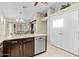 Kitchen features dark wood cabinets and a dishwasher at 14328 W Dusty Trail Blvd, Sun City West, AZ 85375