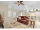 Comfortable living room with a brown couch and ceiling fan at 14328 W Dusty Trail Blvd, Sun City West, AZ 85375