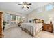 Large main bedroom with ceiling fan and bay window at 14328 W Dusty Trail Blvd, Sun City West, AZ 85375