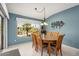 Bright dining area with a wood table and chairs, overlooking the backyard at 14414 W Wagon Wheel Dr, Sun City West, AZ 85375