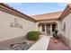 Front entry with decorative metalwork, security door, and potted plants at 14414 W Wagon Wheel Dr, Sun City West, AZ 85375