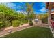 Landscaped backyard with built-in grill and artificial turf at 1534 E Sweet Citrus Dr, Queen Creek, AZ 85140