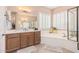 Elegant bathroom with double vanity and soaking tub at 1534 E Sweet Citrus Dr, Queen Creek, AZ 85140