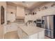 Island kitchen with white cabinets and granite countertops at 1534 E Sweet Citrus Dr, Queen Creek, AZ 85140