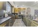 Modern kitchen with gold cabinets and expansive countertop at 15831 E Thistle Dr, Fountain Hills, AZ 85268