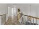 Upstairs hallway with wood flooring and modern gold railing at 15831 E Thistle Dr, Fountain Hills, AZ 85268